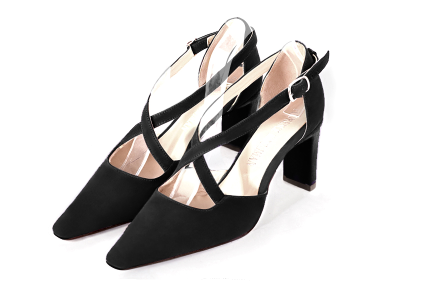 Matt black open side elegant shoes, with crossed straps. Tapered toe. High comma heels.